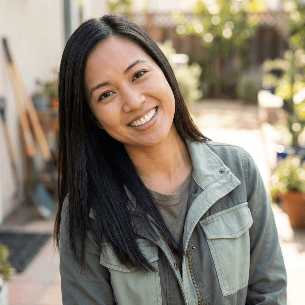 Female cafe owner in her late 30s, East Asian, warm professional appearance in coffee shop